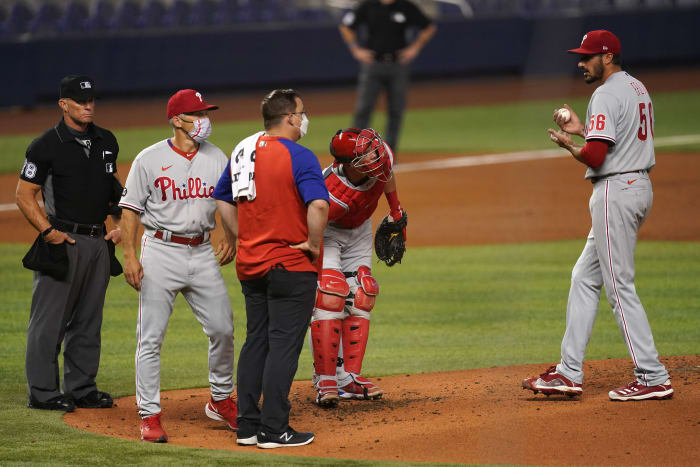 Zach Eflin is visited on the mound by medical trainer Paul Buchheit in Miami